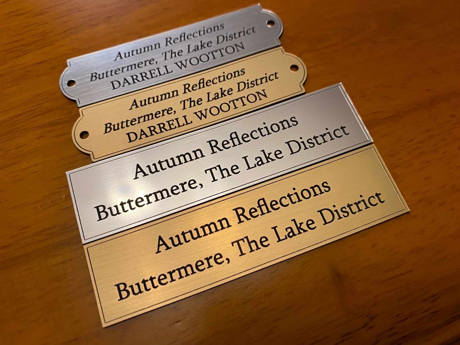 Several engraved plaques in different finishes and borders