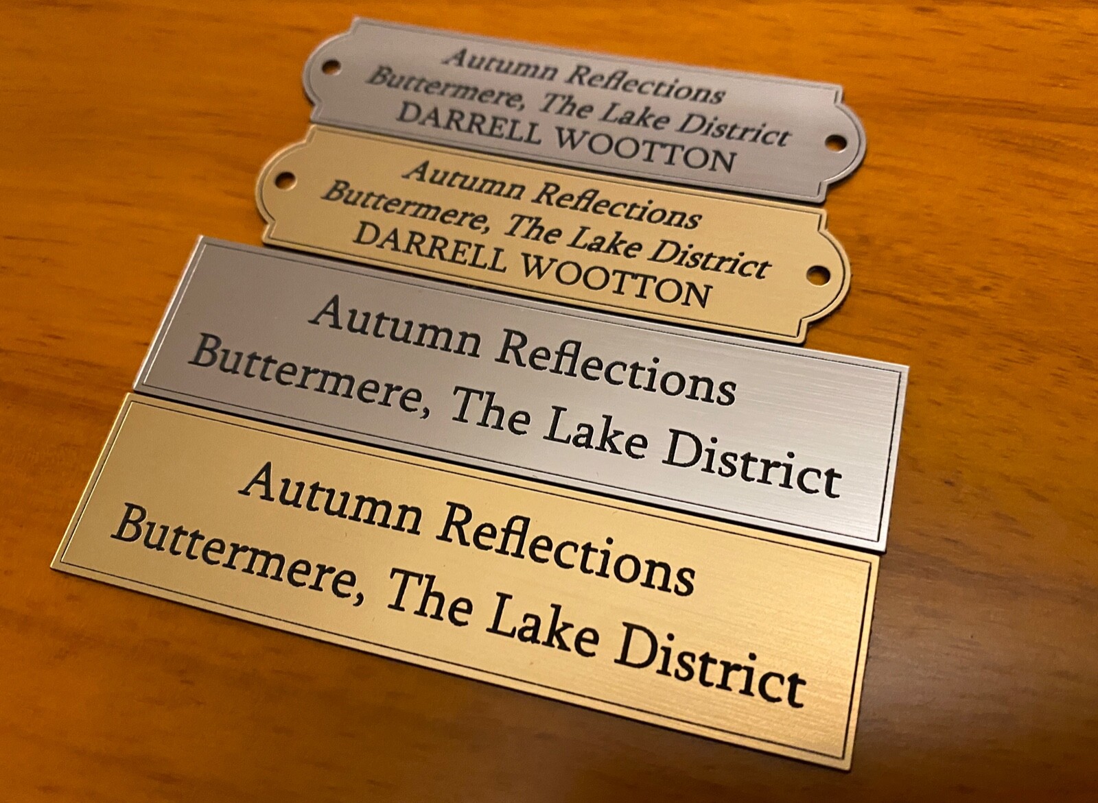 Range of gold and silver plaques in square and rounded borders